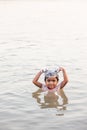 Tribe Bru little girl is smiling and using shampoo while taking shower in the Mekong River in summer hot weather. Bru village,